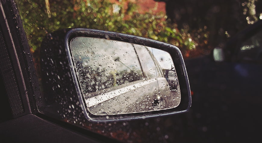 Car Side Mirror with Raindrops on a Wet Day