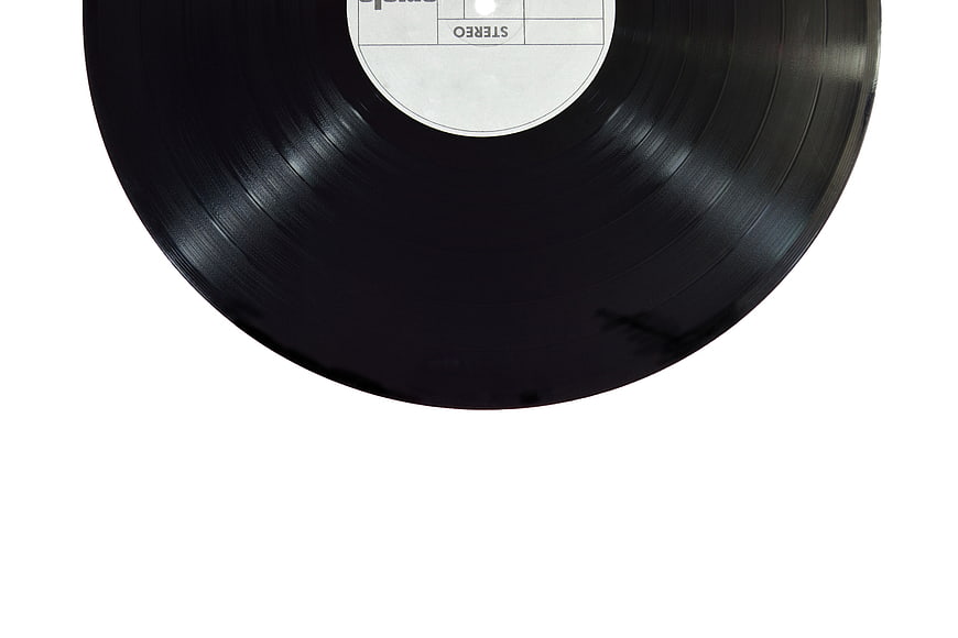 Close-up of black vinyl record with white label on white background