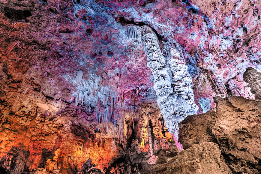 Colorful cave interior with stalactites and stalagmites