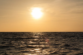Golden Sunset Over Rippling Ocean Waves