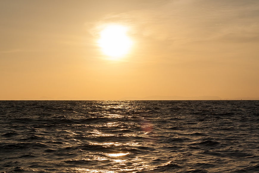 Golden Sunset Over Rippling Ocean Waves