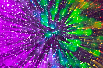 Abstract colorful bokeh explosion with purple and green light particles