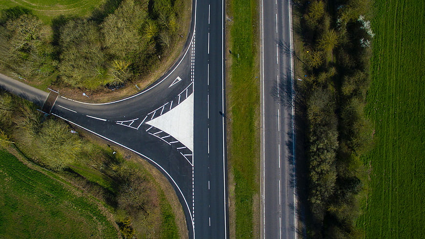 Aerial View of T-Junction Road in Green Countryside