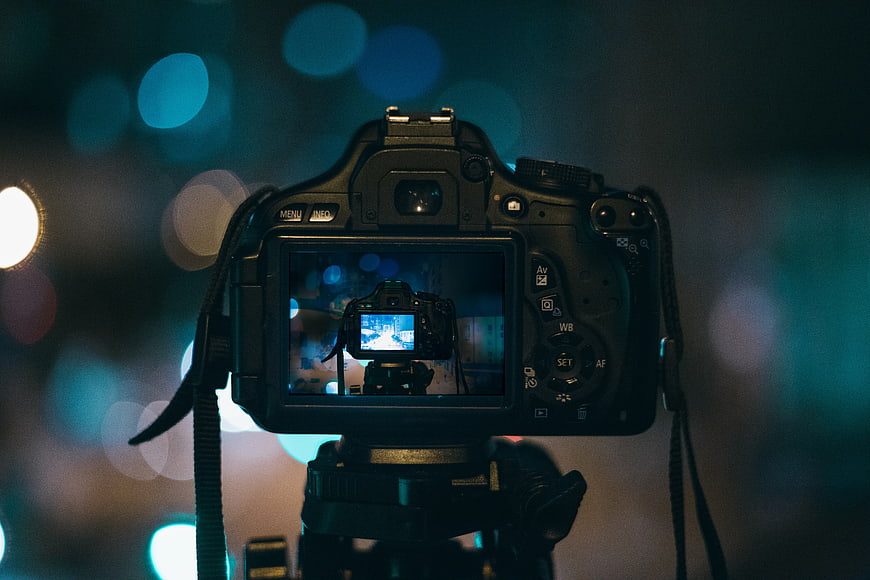 DSLR Camera on Tripod with Bokeh Background