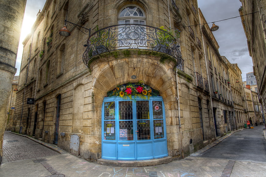 Blue door on historic stone building in narrow European street