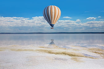 Hot Air Balloon Flying Over Salt Lake Reflection