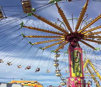 Colorful Carnival Swing Ride Against Blue Sky