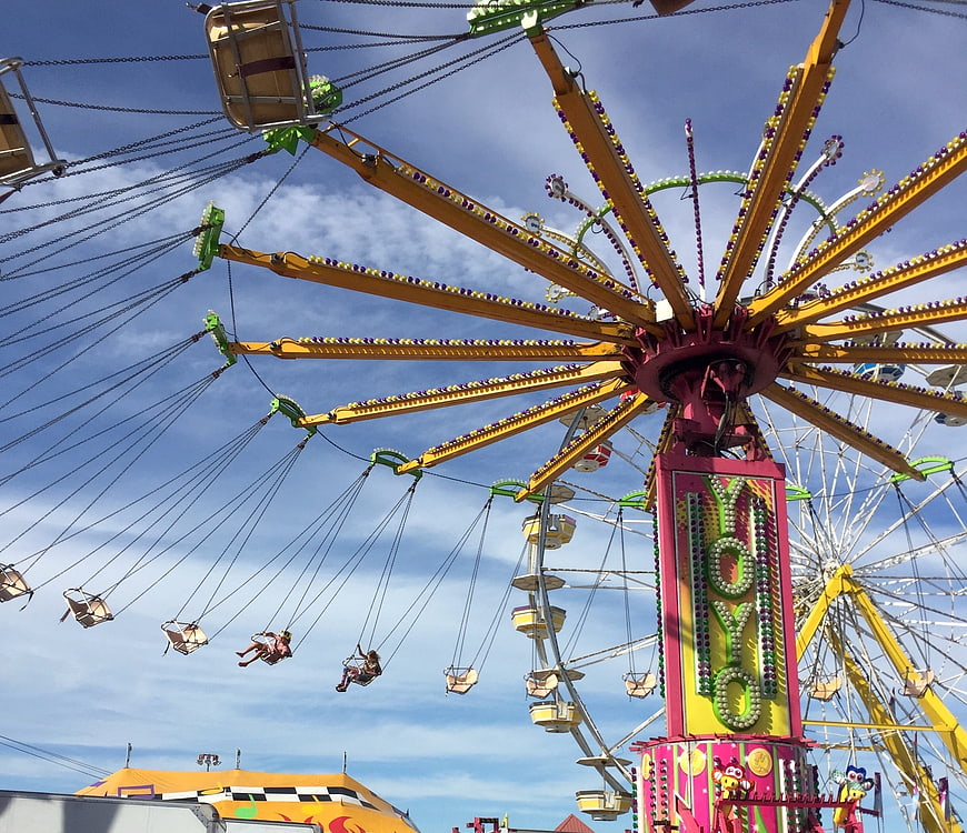 Colorful Carnival Swing Ride Against Blue Sky