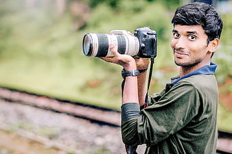 Young Photographer Holding DSLR Camera Outdoors