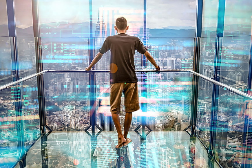 Man on Glass Floor with Futuristic City Hologram Overlay