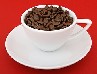 White Coffee Cup Filled With Roasted Beans On Red Background