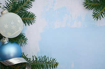 Christmas ornaments and pine branches on blue background