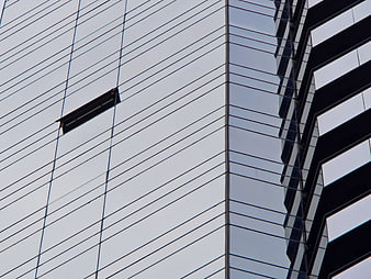 Modern Glass Skyscraper Facade with Geometric Reflections