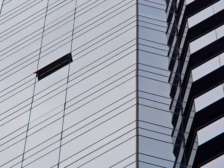 Modern Glass Skyscraper Facade with Geometric Reflections