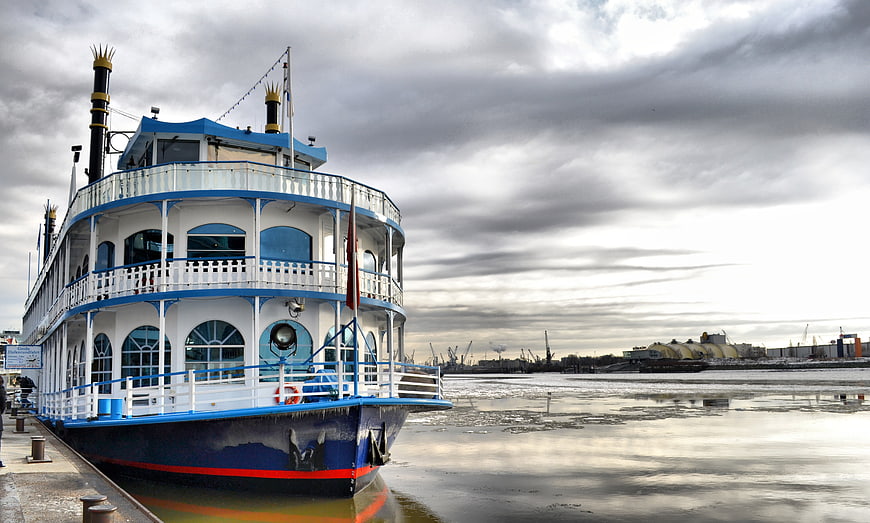 Blue and white paddle steamer docked at Hamburg port