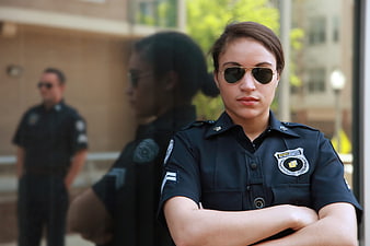 Female Police Officer in Uniform with Sunglasses