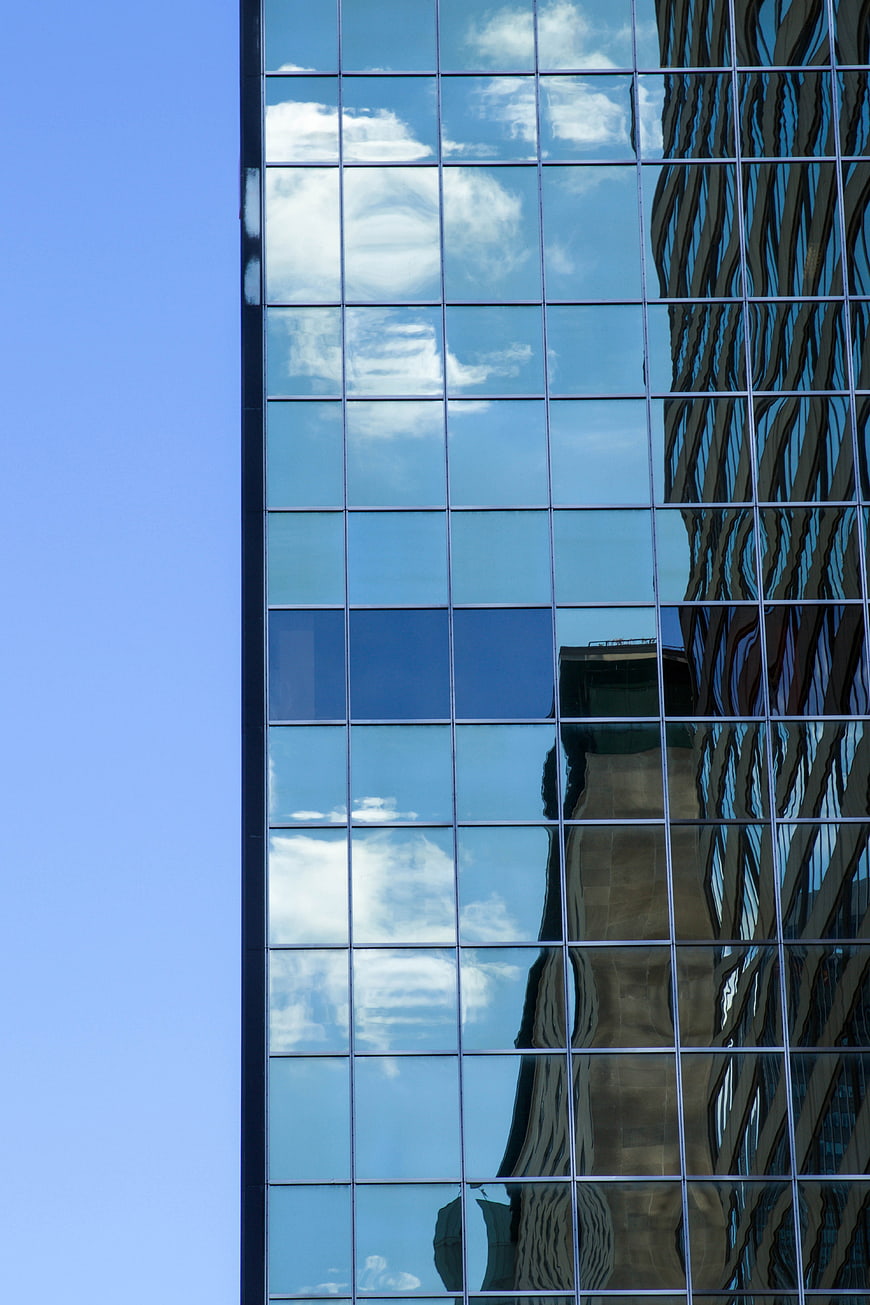 Modern Glass Skyscraper with Cloud Reflections