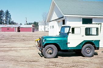 Vintage Green and White Jeep Station Wagon on Farm