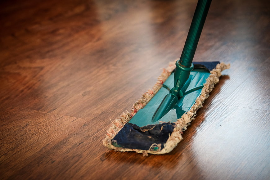 Green Mop Cleaning Polished Wooden Floor
