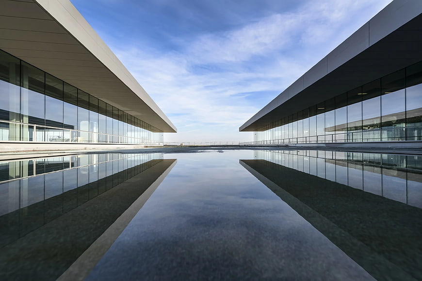Modern Glass Architecture with Symmetrical Water Reflection