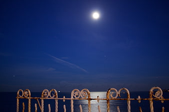 Full Moon Over Ocean with Rusty Balcony Railing