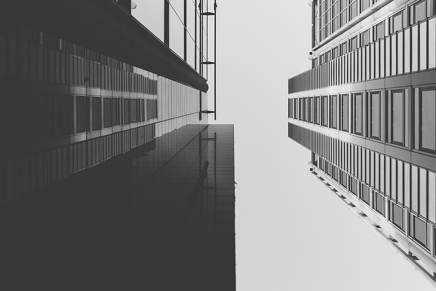 Black and white modern architecture looking up at skyscrapers