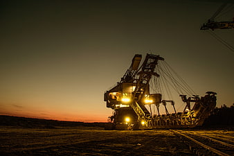Illuminated Bucket-Wheel Excavator at Sunset in Mining Site