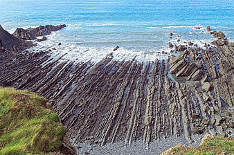 Dramatic layered rock formations on a rugged coastal cliff