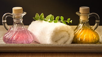 Spa Wellness Still Life With Glass Carafes, Towel, And Green Leaves