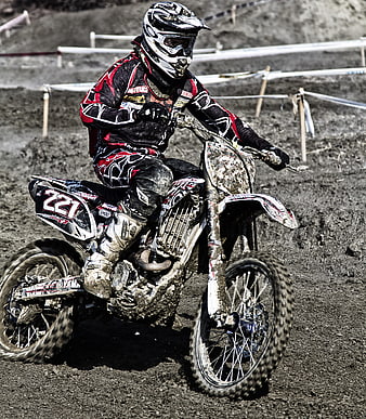 Motocross Rider On Dirt Bike Racing On Muddy Track