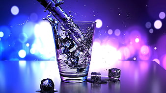 Water Pouring Into Glass With Ice Cubes Against Neon Purple Background