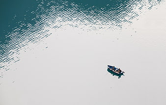 Aerial view of small boat on calm turquoise water