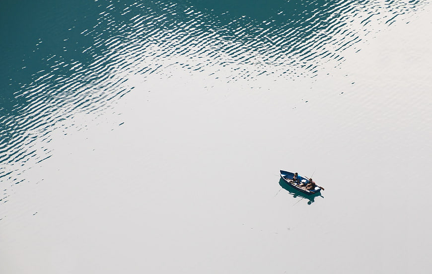 Aerial view of small boat on calm turquoise water