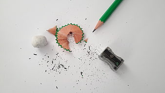 Green Pencil, Sharpener, and Shavings on White Background