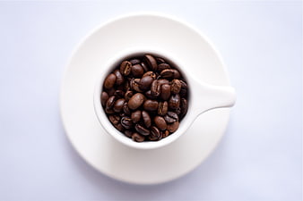 Top View of Coffee Beans in White Cup on Saucer