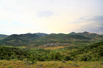 Scenic mountain village nestled in green valley landscape