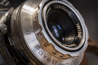 Close-up of vintage Paxette camera lens with aperture details