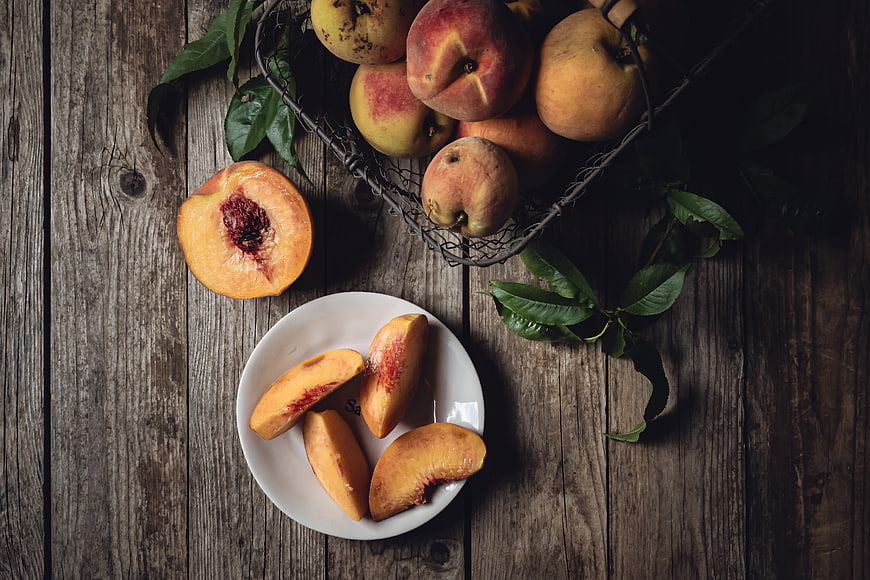 Rustic Flat Lay of Fresh Peaches on Wooden Table
