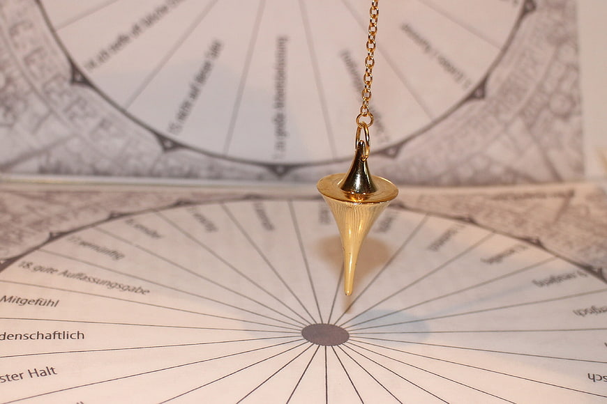 Golden pendulum over radiesthesia chart for dowsing