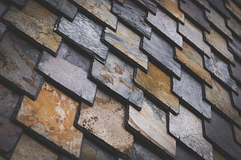 Close-up of textured slate roof tiles in earthy tones