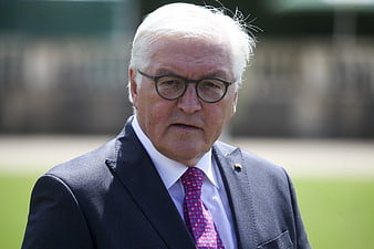 Portrait of Senior Politician in Suit and Glasses Outdoors