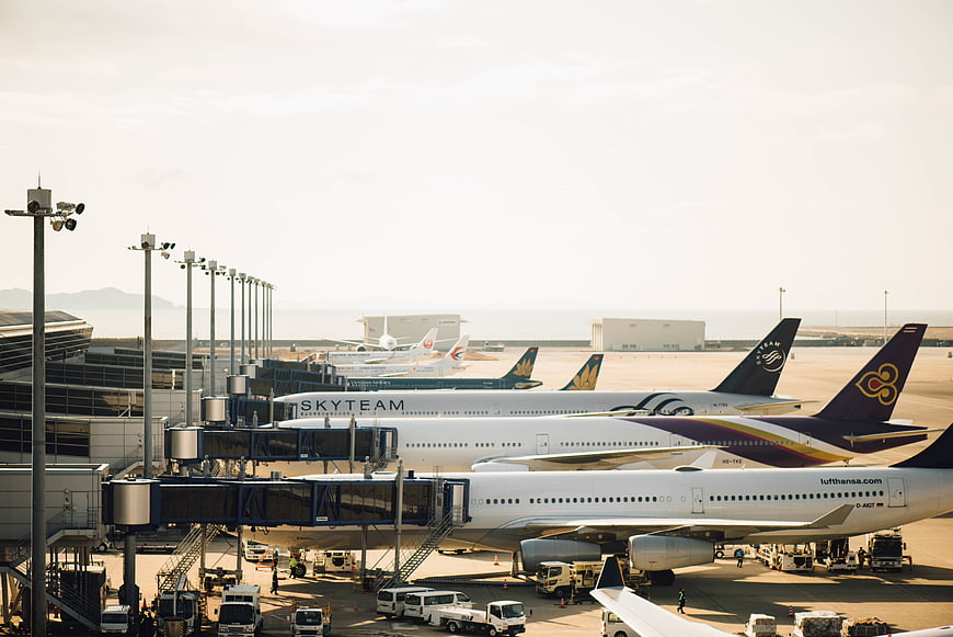 Busy Airport Tarmac with Parked Airplanes and Ground Vehicles
