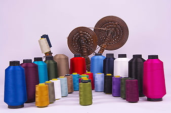 Colorful Spools of Thread and Wooden Spinning Wheels