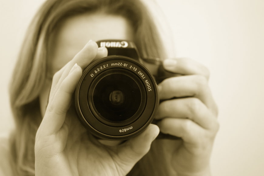 Female Photographer Holding Canon DSLR Camera Lens Close Up