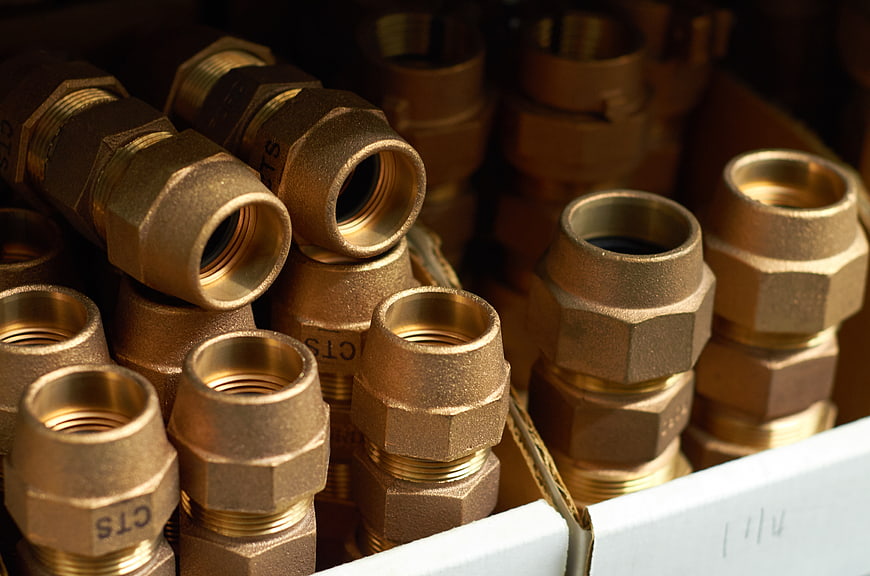Close-up of brass plumbing fittings in a box