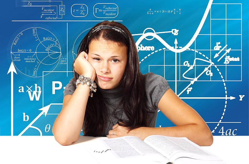 Bored teenage girl studying with math equations on blue background