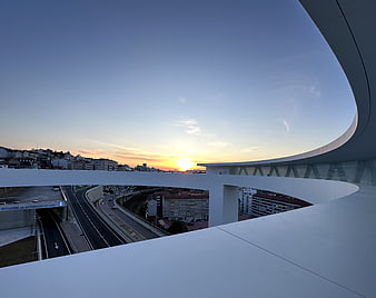 Modern white bridge architecture at sunset over highway