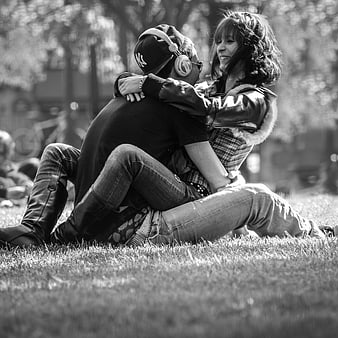 Young couple embracing on grass in black and white