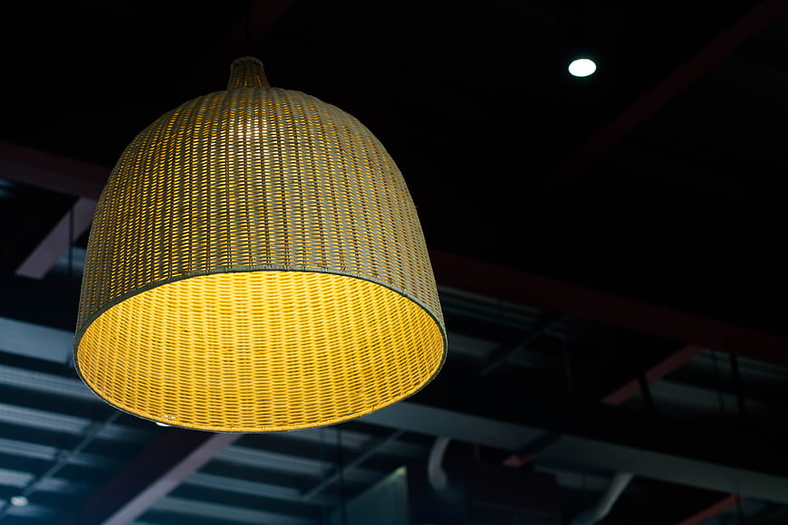 Woven rattan pendant lamp glowing warm yellow light