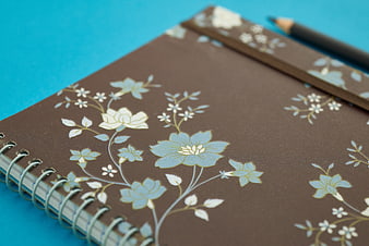 Brown Floral Spiral Notebook on Blue Background